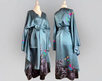 May include: A teal blue silk robe with a wrap closure and long sleeves. The robe features a floral print with colorful butterflies.