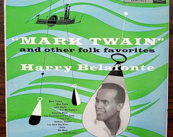 May include: Vintage vinyl record album cover for "Mark Twain and Other Folk Favorites" by Harry Belafonte. The cover features a green and blue design with a portrait of Belafonte and the album title in large white letters. The RCA Victor logo is visible.