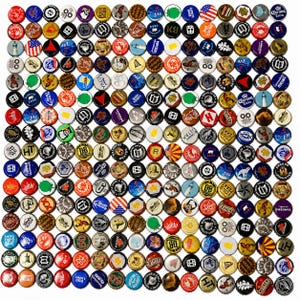 May include: A large collection of assorted metal bottle caps arranged in a grid pattern. The caps feature a wide variety of colors, including red, blue, yellow, green, black, and white, with various printed logos, symbols, and graphic designs.