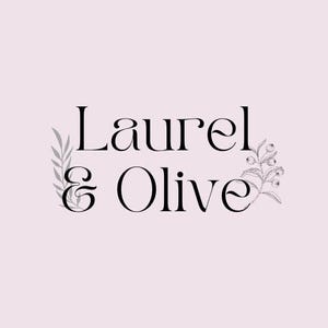 May include: A logo design featuring the words "Laurel & Olive" in a stylish serif font. The text is black against a pale pink background. Decorative botanical illustrations, including leaves and berries, frame the text.