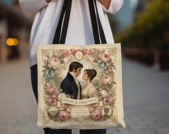 May include: A cream-colored tote bag with black shoulder straps featuring a central illustration of a couple in historical attire surrounded by a floral frame. The text reads Pride & Prejudice, along with a quote and the initials DE in a gold crest.
