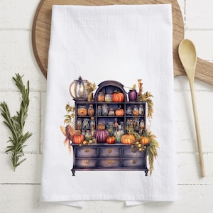 May include: A dark wood cabinet with multiple drawers and shelves filled with glass jars and pumpkins. The cabinet is decorated with fall foliage and has a vintage aesthetic.