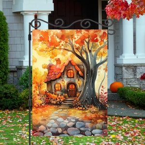 May include: A watercolour painting of a small cottage with a red roof and a stone path leading to the front door. The cottage is surrounded by trees with orange and yellow leaves. The scene is set in a forest with a soft, golden light.