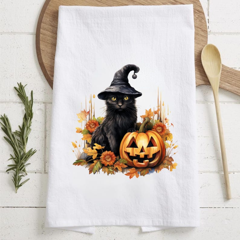 May include: A black cat wearing a witch's hat sits next to a jack-o'-lantern with fall leaves around them.