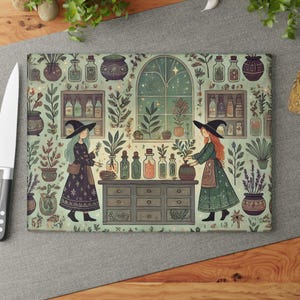 May include: Rectangular cutting board with a whimsical illustration of two witches in a botanical setting. The design features shelves of potion bottles, plants, and a starry window. The color palette includes shades of green, brown, and beige.