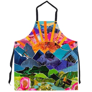 May include: A colorful apron with a collage design featuring a sunrise over mountains. The design is made up of various pieces of paper in shades of orange, yellow, pink, purple, blue, and green.