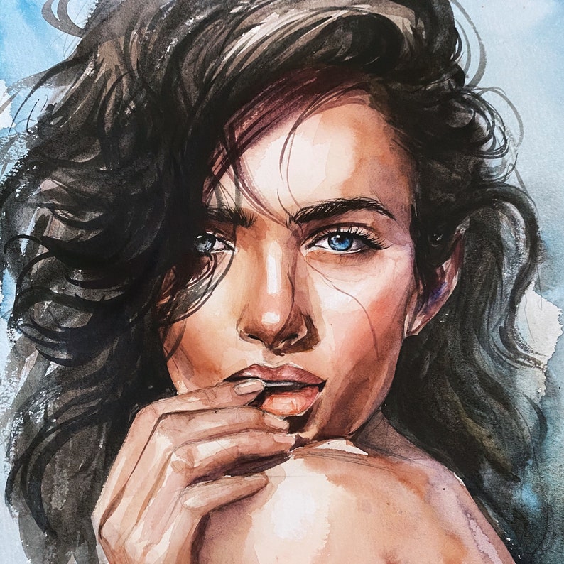 May include: A watercolor painting of a face with dark, wavy hair and bright blue eyes. The subject has a hand near their mouth, with visible brushstrokes and ink lines defining the facial features, skin tones, and hair against a blue wash.