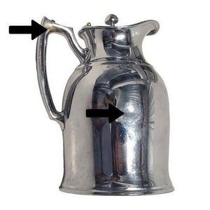 K&ouml;nnte beinhalten: Eine gl&auml;nzende, silberfarbene Kanne mit gebogenem Griff und Deckel mit kleinem Knauf. Die Kanne hat einen abgerundeten K&ouml;rper und einen Ausguss zum Ausgie&szlig;en. Die Oberfl&auml;che reflektiert das Licht und erzeugt ein helles, metallisches Aussehen.