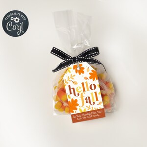 May include: A cellophane bag filled with candy corn, tied with a black and white ribbon. A tag with the words "hello fall" and autumn leaves is attached. The tag also includes the text "So Very Thankful For You! Love, The Smith Family."