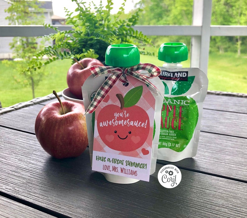 May include: A red apple-shaped gift tag with the text "you're awesomesauce!" and "Have a great summer! Love, Mrs. Williams". The tag is tied to a pouch of organic apple sauce with a green lid.