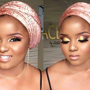 May include: A woman with a pink velvet turban and gold eyeshadow makeup.