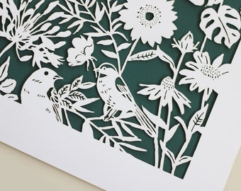 May include: White paper cut-out art depicting a garden scene with birds, flowers, and leaves. The background is a deep teal green.