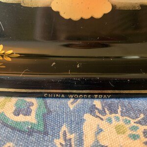 Pu&ograve; includere: Vassoio nero con bordo dorato e motivo floreale. Sul fondo del vassoio &egrave; stampato "China Woods Tray".