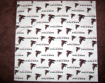 May include: White fabric with a repeating pattern of the Atlanta Falcons logo. The logo is red and black with the words "Atlanta Falcons" written below it.
