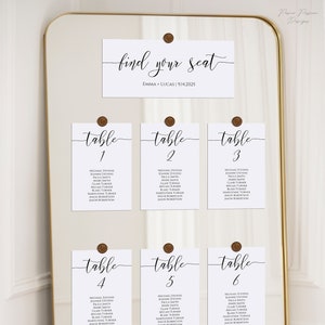 wedding seating chart cards placed with wax seals on a modern gold frame mirror.  9 table cards are displayed with table numbers and guest names. find your seat card with bride and groom names and wedding date displayed above the table cards.