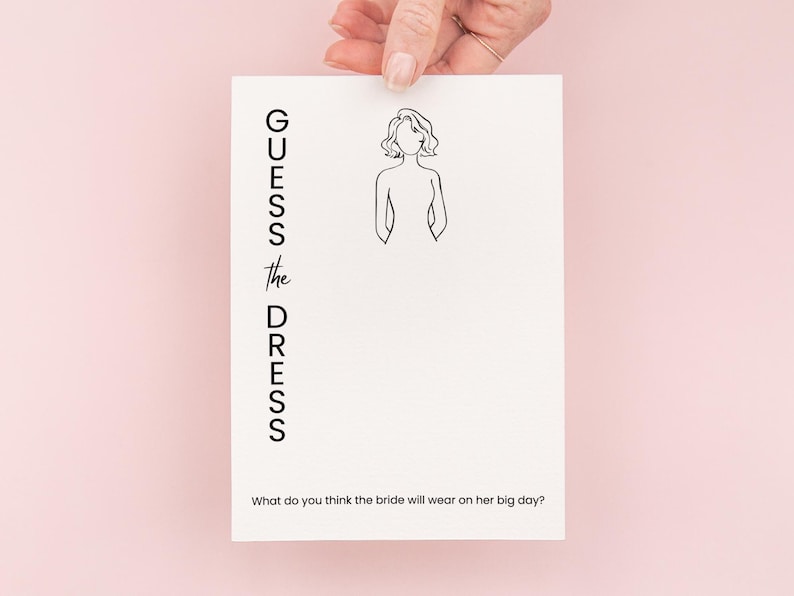 May include: A white card with the text "GUESS the DRESS" and a line drawing of a woman. The text below the drawing asks "What do you think the bride will wear on her big day?"