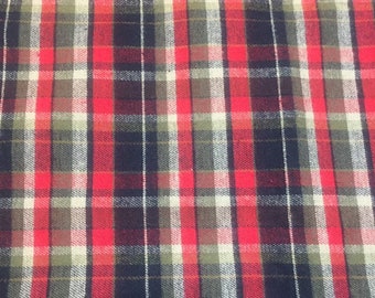 May include: Red, black, white, and green plaid fabric with a woven texture.