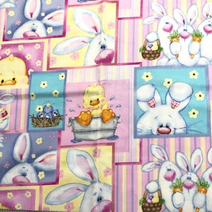 May include: Fabric with a repeating pattern of cartoon bunnies, ducklings, and birds. The bunnies are white with pink ears and noses, some holding carrots or baskets. The ducklings are yellow, and the birds are blue. The background has pastel colors.