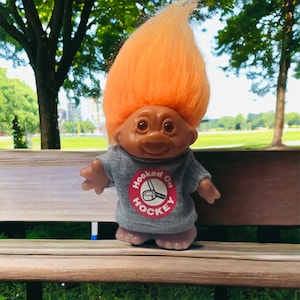 Vintage 1986 DAM First Generation 5&quot; Troll &quot;Hooked On Hockey&quot; With Orange Hair Wearing Gray Sweatshirt Showing Hockey Stitch & Puck