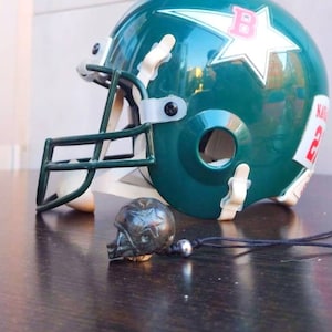 Hand-carved American football helmet made of xylopal (a 200-million-year-old fossil plant)