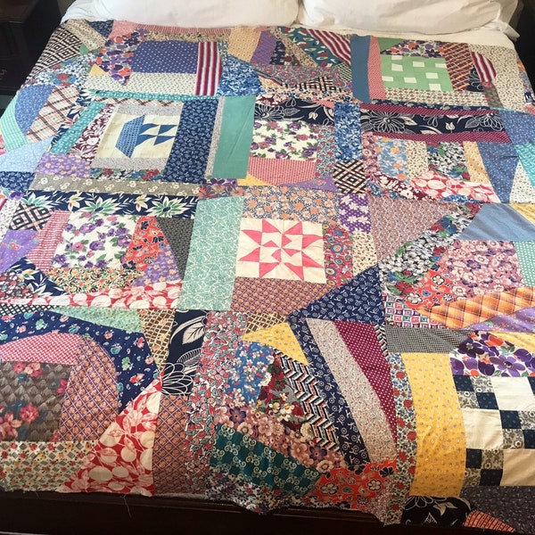 Very colorful vintage quilt top.  Crazy quilt!  Fabrics look to be from 60’s.  It has 4 quilt squares incorporated in it! Big! 73” x 94”.