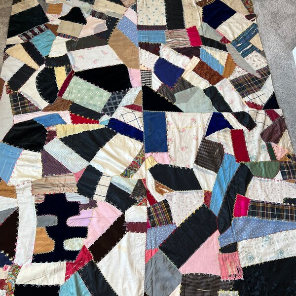 Early 1900’s crazy quilt.  Velvets, satins, silks and cottons.  Embroidered beautifully. See description below.