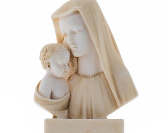 May include: A white ceramic sculpture of the Virgin Mary holding a baby Jesus. The sculpture is on a white base.
