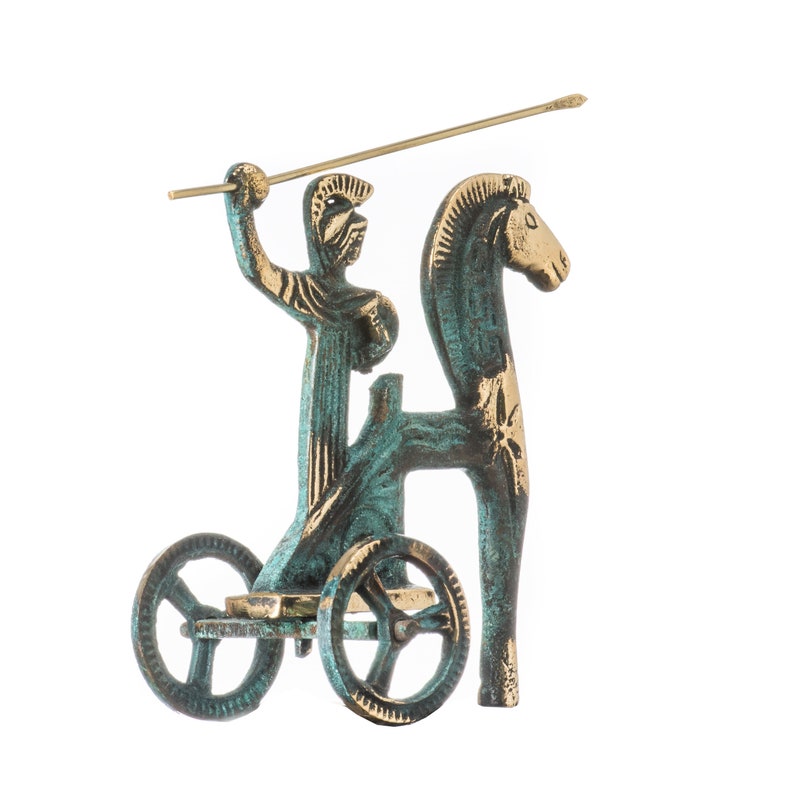 May include: A bronze-toned sculpture of a warrior in a chariot pulled by a horse. The warrior holds a spear, and the chariot has two wheels. The sculpture has a verdigris finish, with gold accents on the horse and chariot.