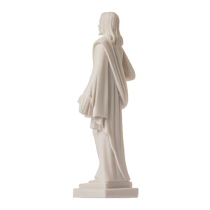May include: White marble statue of a person wearing a long robe, standing on a square base.