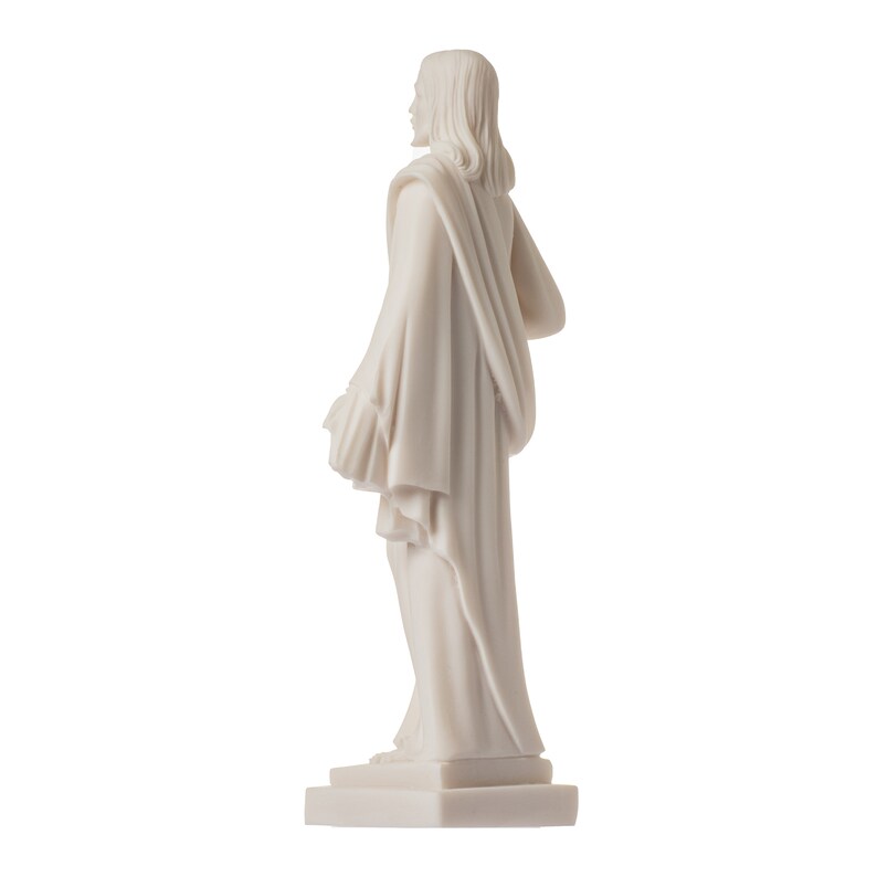 May include: White marble statue of a person wearing a long robe, standing on a square base.