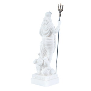 May include: White marble statue of Poseidon, the Greek god of the sea, holding a trident. The statue is standing on a white base.
