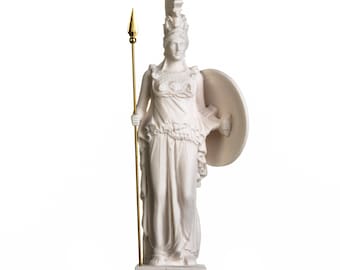 May include: White marble statue of Athena, the Greek goddess of wisdom and warfare, holding a spear and shield. The statue is on a base with the word "Athena" inscribed on it.