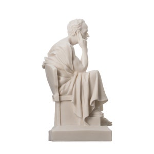 May include: White marble statue of a seated figure with a thoughtful expression, holding their chin with their hand. The figure is wearing a toga-like garment and is seated on a throne-like structure.