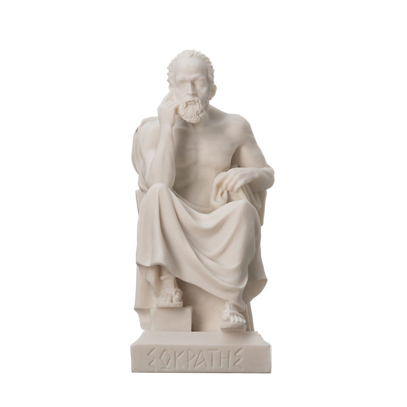 May include: White marble statue of the Greek philosopher Socrates sitting on a stone bench. The statue is detailed and shows Socrates with a beard and a thoughtful expression. The base of the statue is inscribed with the word "&Sigma;&Omega;&Kappa;&Rho;&Alpha;&Tau;&Eta;&Sigma;" in Greek.