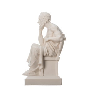 May include: White marble statue of a seated man with a beard, wearing a toga and holding his chin in thought. The statue is on a white base.