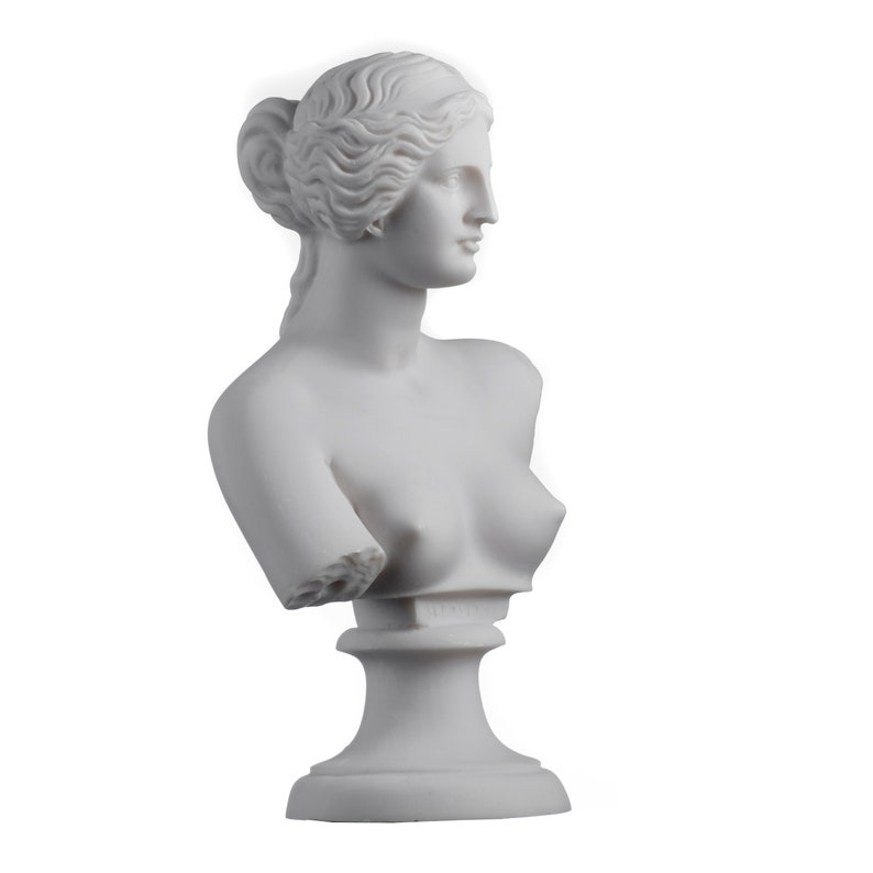 May include: White marble bust sculpture of a woman with a detailed hairstyle. The sculpture is on a white pedestal.
