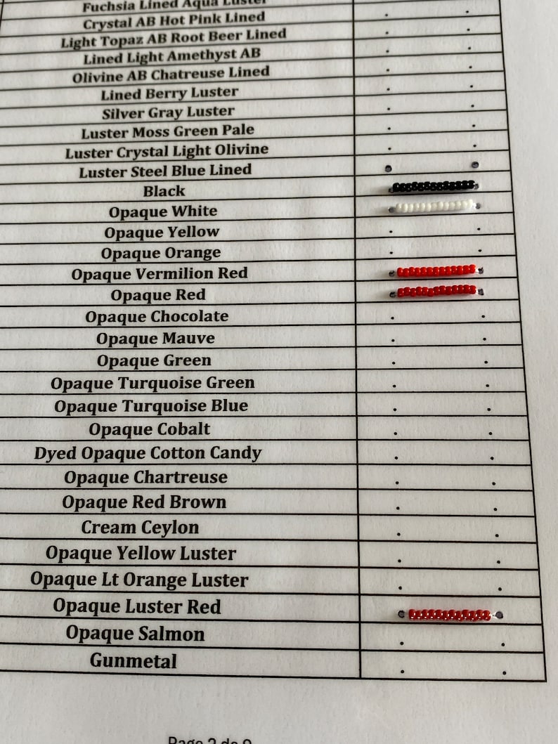 May include: A chart with a list of bead colors and their corresponding names. The colors are displayed in rows with small beads next to each name. The colors include fuchsia, crystal, light topaz, lined light amethyst, olivine, lined berry, silver gray, luster moss green, luster crystal, luster steel blue, black, opaque white, opaque yellow, opaque orange, opaque vermilion red, opaque red, opaque chocolate, opaque mauve, opaque green, opaque turquoise green, opaque turquoise blue, opaque cobalt, dyed opaque cotton candy, opaque chartreuse, opaque red brown, cream ceylon, opaque yellow luster, opaque light orange luster, opaque luster red, opaque salmon, and gunmetal.