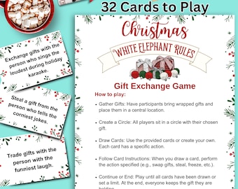 May include: A Christmas White Elephant gift exchange game set. The set includes 32 cards with rules and instructions. The cards are decorated with festive holiday graphics and text. A mug of hot chocolate with marshmallows is in the upper left corner.