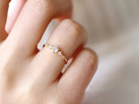 Dainty moissanite engagement best sale ring