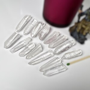 15 pieces Raw Lemurian Seed Crystal points from Brazil.
You choose the exact 15 pieces from the drop down menu.  
all items are under 100 grams in weight total.
63 grams
15 pieces
baby Lemurian quartz crystals
