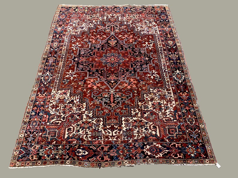 May include: A large, intricately patterned rug with a red, blue, and white color scheme. The rug features a central medallion with a geometric design and a border with floral motifs.