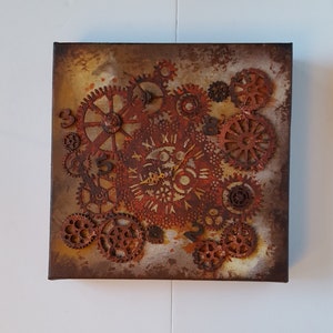 May include: A square canvas painting with a rusty brown background featuring a clock face with Roman numerals and cogs. The clock face is surrounded by smaller cogs and numbers.