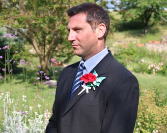 Buttonholes made with paper flowers for long lasting reusable corsages for weddings and special events
