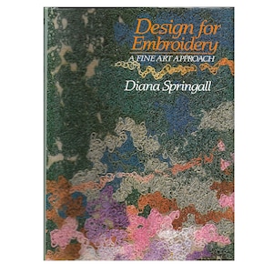 May include: A book titled "Design for Embroidery" by Diana Springall. The cover features a dark green background with colorful, abstract embroidery designs in shades of pink, purple, orange, blue, and gray. The title is in orange and the author's name is in white.
