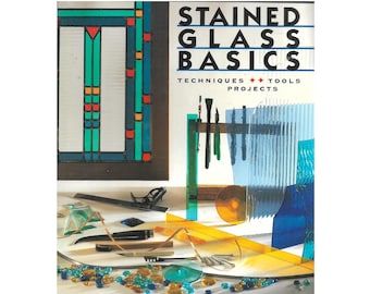 May include: A book titled "Stained Glass Basics: Techniques, Tools, Projects" by Chris Rich with Martha Mitchell and Rachel Ward. The cover features a colorful stained glass window design and tools used in stained glass making.