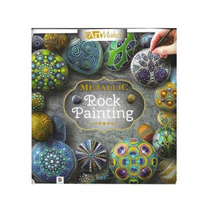 May include: The cover of a book titled "Metallic Rock Painting" displays a collection of painted rocks. The rocks are adorned with metallic paints and detailed patterns. The image also includes the "ArtMaker" logo.
