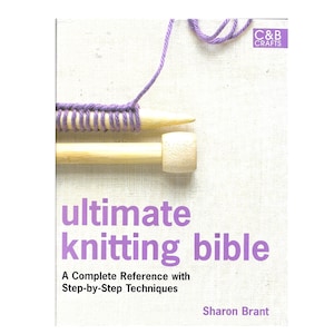 May include: A book titled "ultimate knitting bible" with a purple yarn and knitting needles on the cover. The book is a complete reference with step-by-step techniques by Sharon Brant.