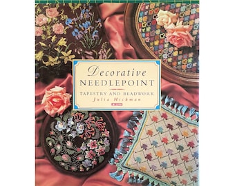May include: A book titled "Decorative Needlepoint: Tapestry and Beadwork" by Julia Hickman. The cover features a variety of needlepoint projects, including a floral design, a geometric pattern, and a design with leaves.