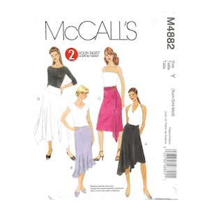 May include: McCall's sewing pattern M4882 for a 2-hour skirt in sizes X-Small, Small, and Medium. The pattern includes instructions for three different skirt styles: a white skirt with a ruffled hem, a lavender skirt with a ruffled hem, and a black skirt with a draped front.