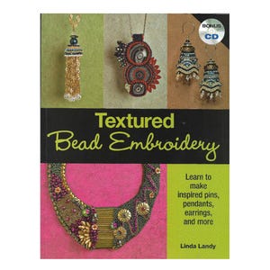 May include: A book titled Textured Bead Embroidery by Linda Landy featuring a cover with various beaded jewellery pieces, including a necklace, pendant, and earrings, with a bonus CD included. The cover displays colourful beadwork designs.
